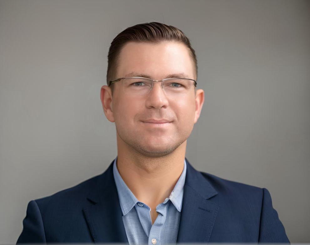 a man wearing glasses and a suit